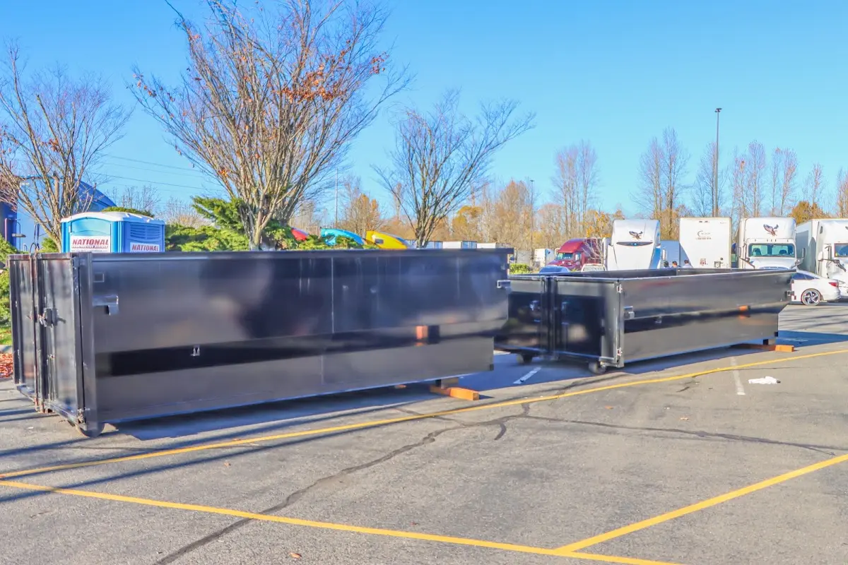 Professional dumpster rental service with roll-off container on residential driveway in South Brunswick